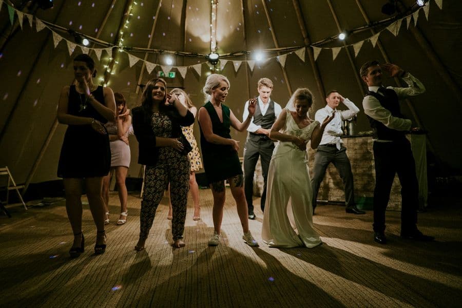 Guests dancing at an evening party under bunting