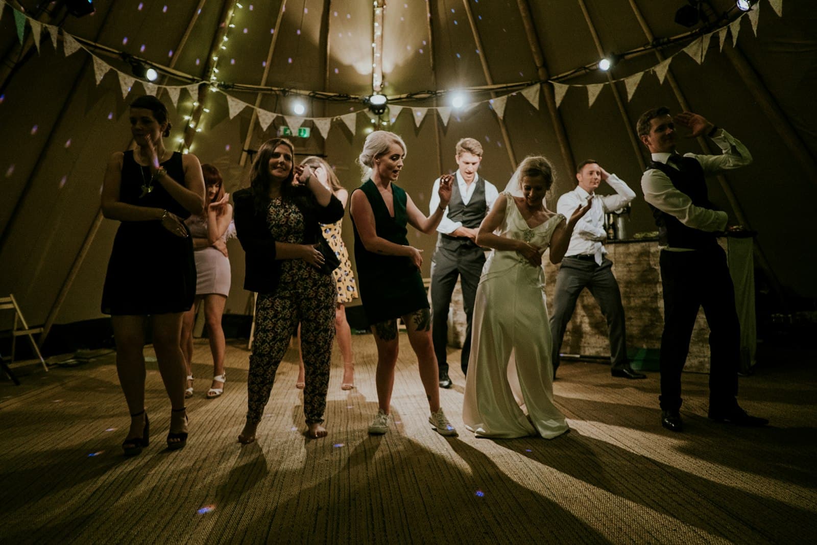 Guests dancing at an evening party under bunting