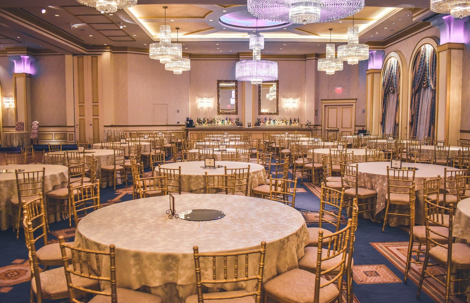 Grand ballroom with chandeliers set for a reception