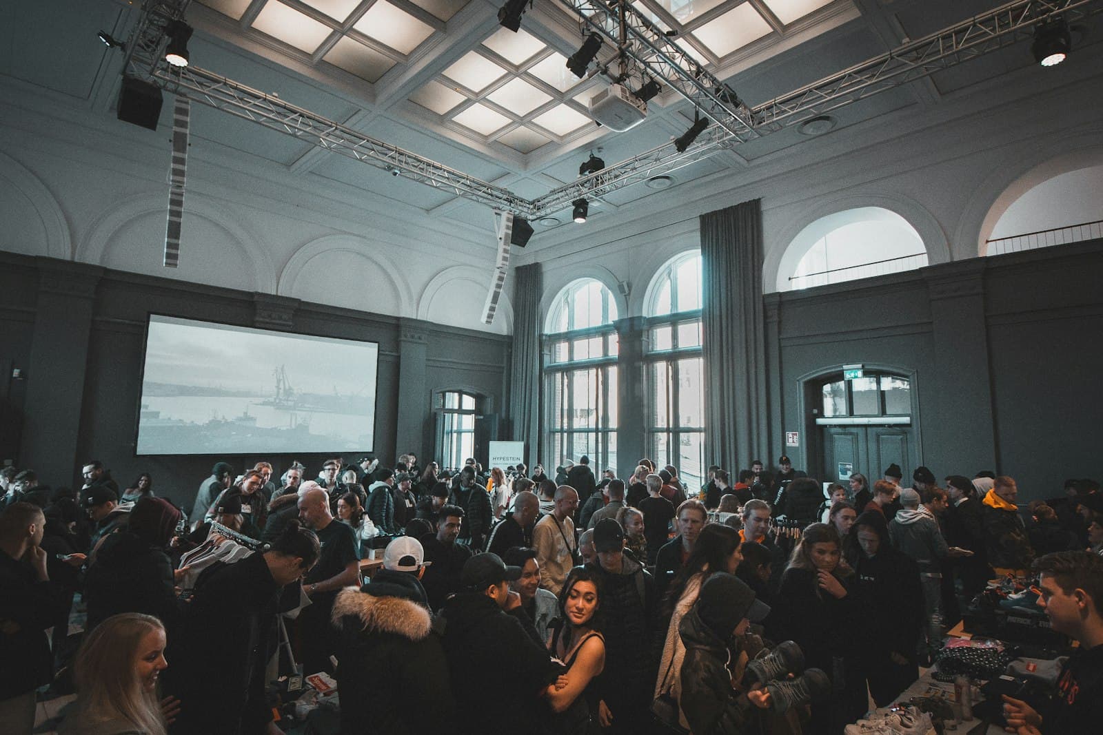 Guests mingling in a bright gallery event space