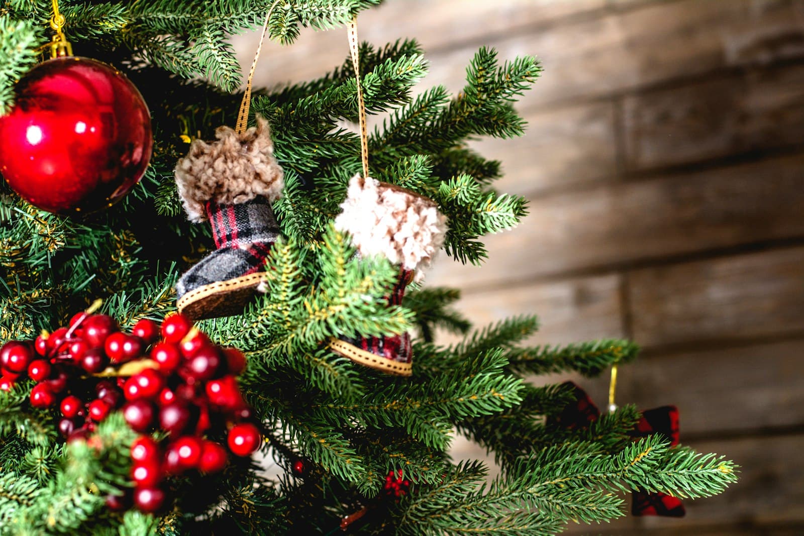 Christmas tree branches with red berries and ornaments