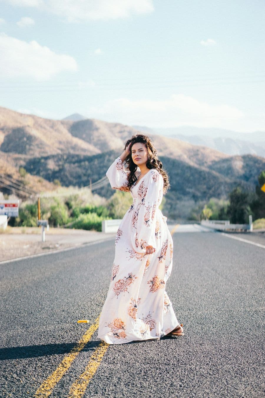 Mother-to-be in a floral gown at golden hour