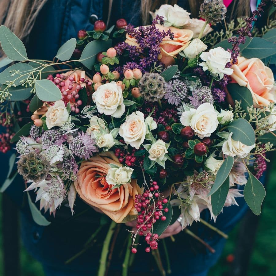 Lush hand-tied bouquet in peach, cream and plum