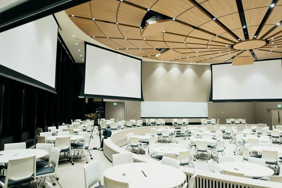 Modern hall with round tables set for a company event
