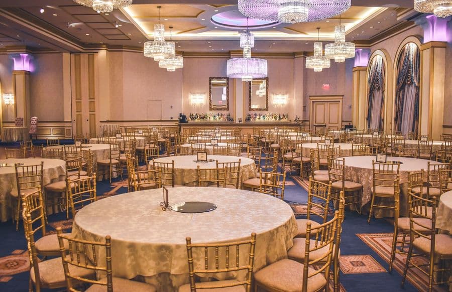 Grand ballroom with chandeliers set for a reception